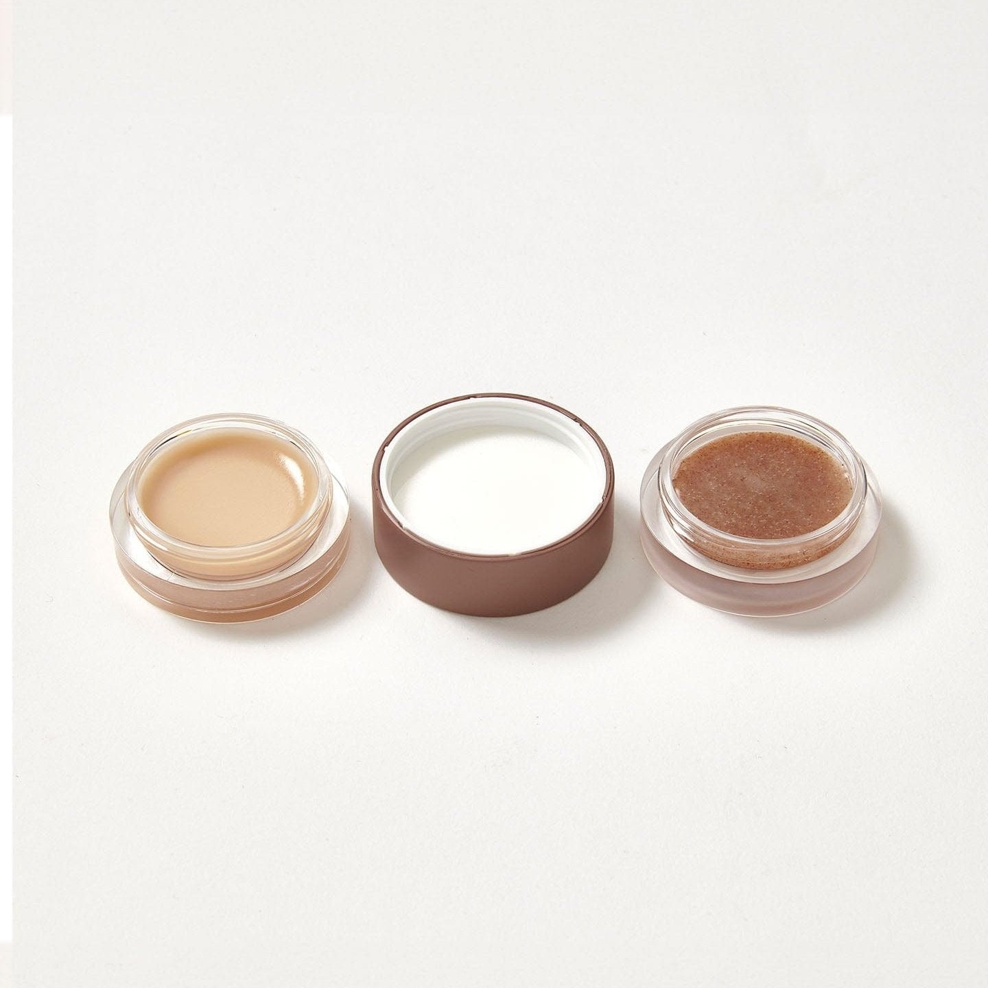 A lip balm and scrub duo in the flavour Caramel Latte open on both sides.