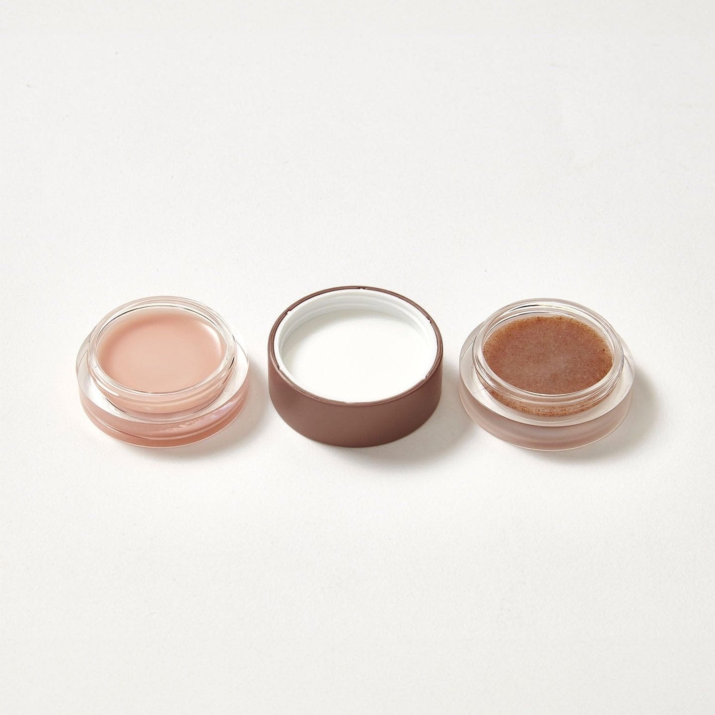 A lip balm and scrub duo in the flavour Peach Cobbler open on both sides.