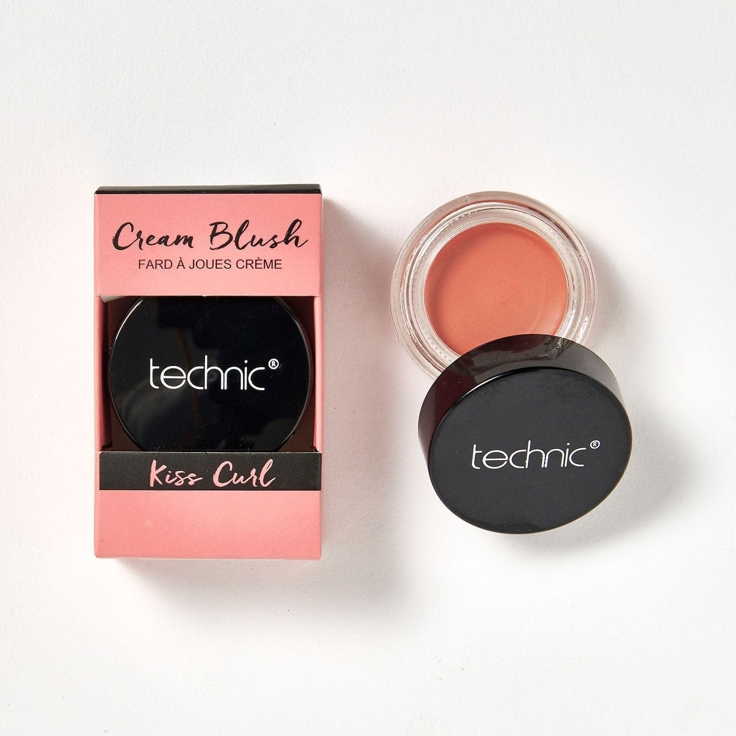 2 cream blushes in the shade Kiss Curl next to each other on a white background. 1 is in its pink coloured box packaging and the other is opened.