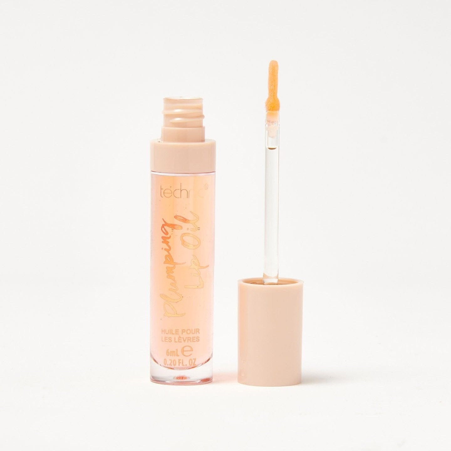 An opened plumping lip oil in the shade Everythings Peachy on a white background