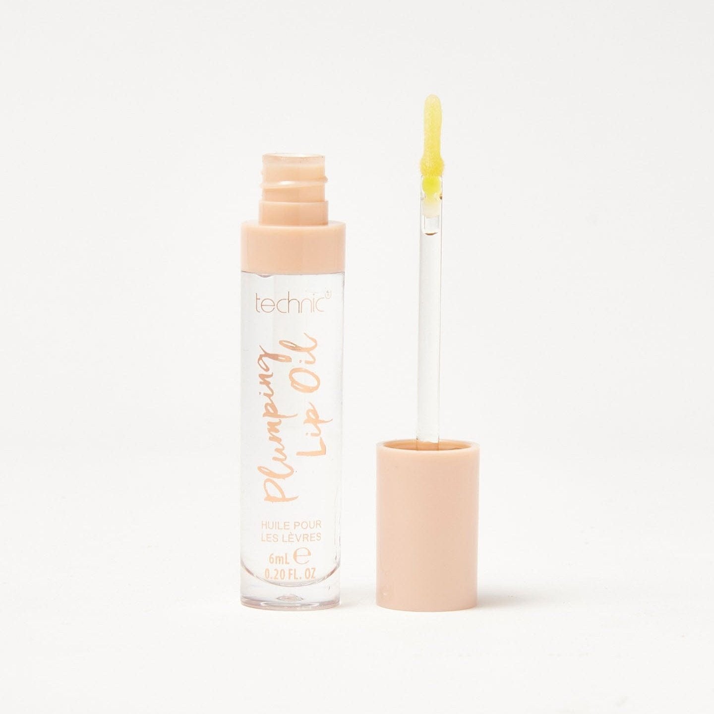 An open plumping lip oil in the shade Sweet Thing on a white background.