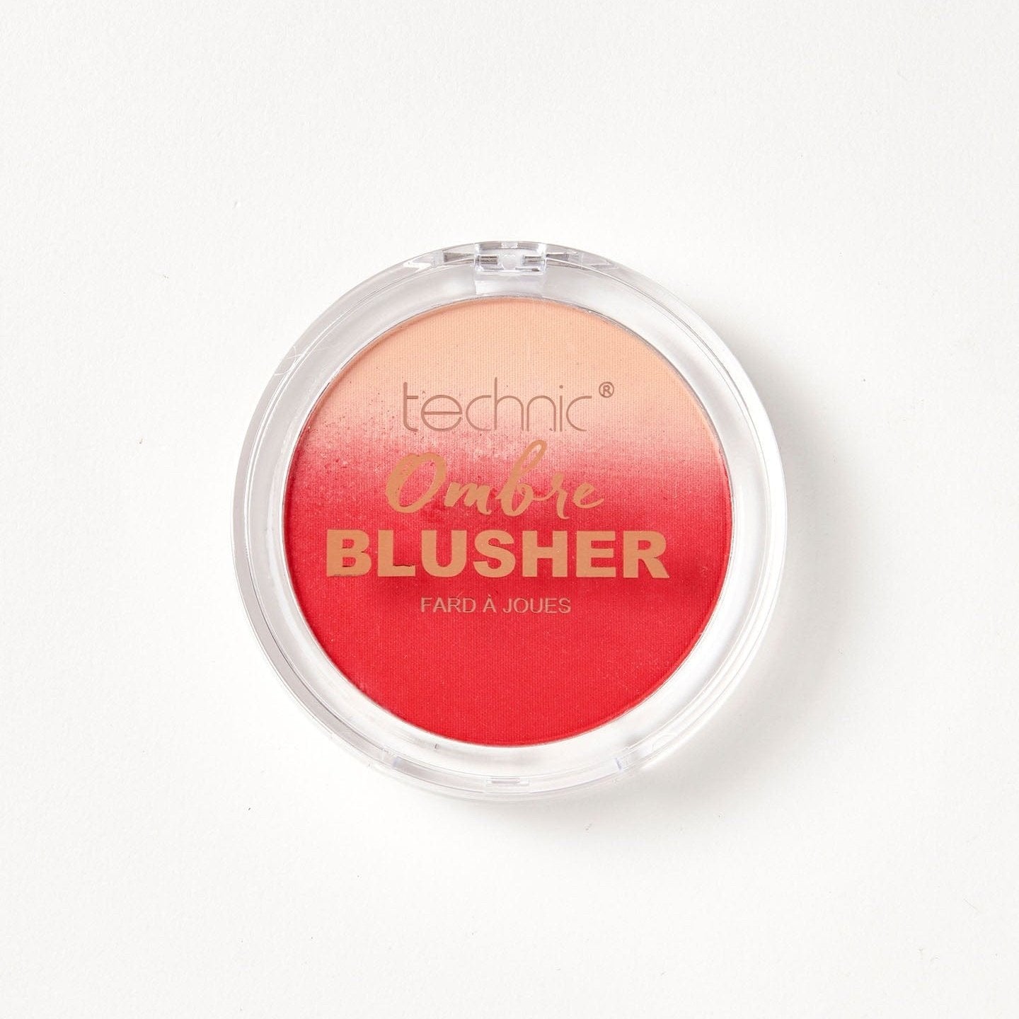 An ombre blusher in the shade Beach Happy on a white background. The blusher has an ombre of cream and red.