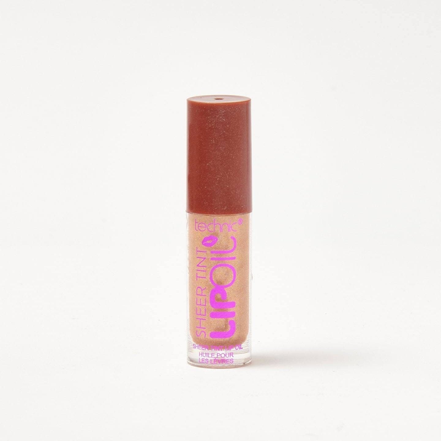 A sheer lip oil in the shade Champagne Season on a white background.