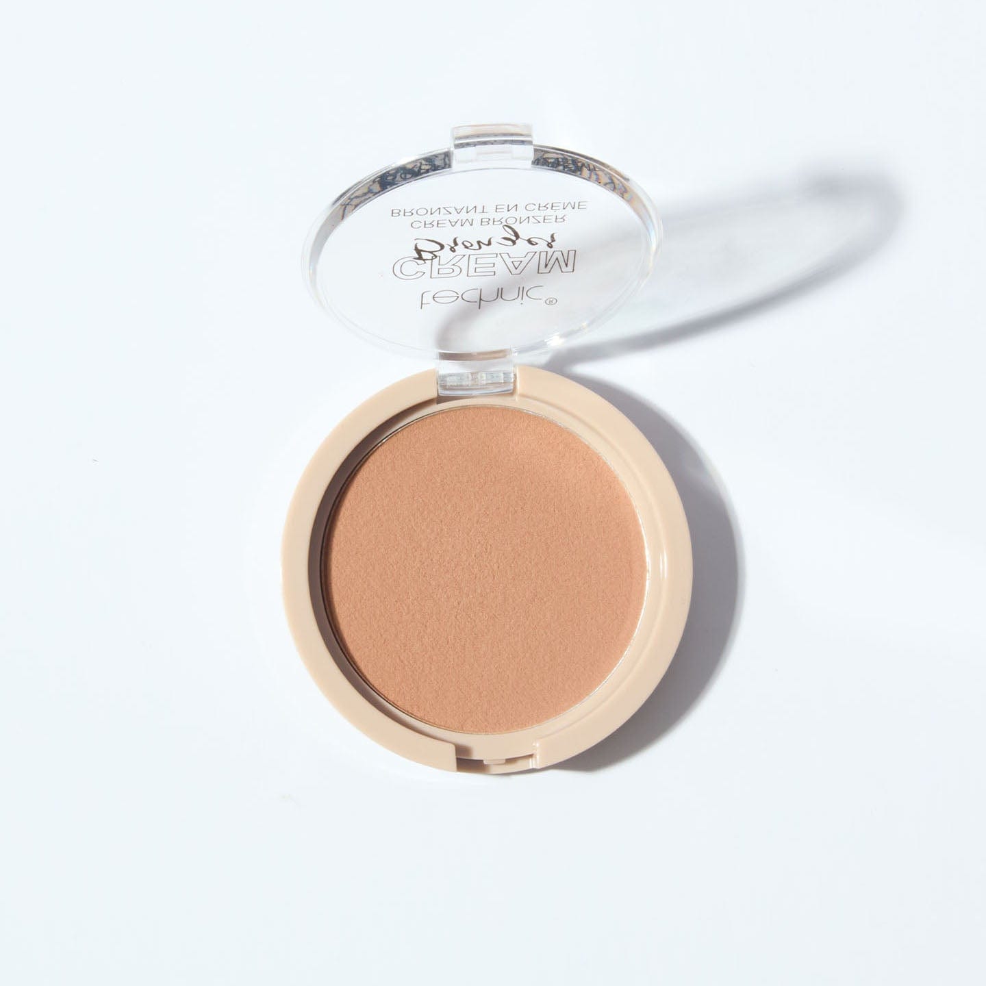 An opened cream bronzer in the shade Light on a white background.