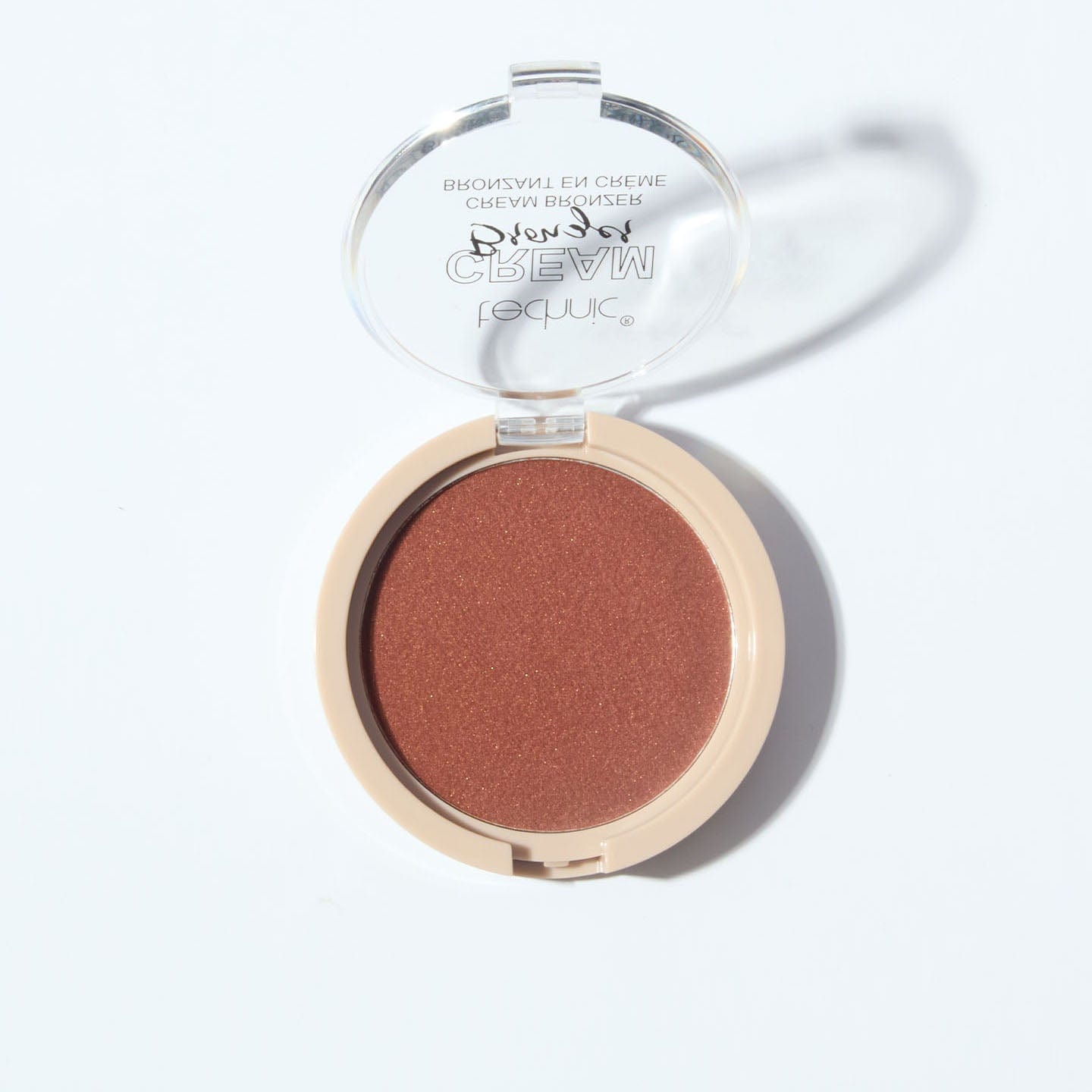 An opened cream bronzer in the shade Dark on a white background.