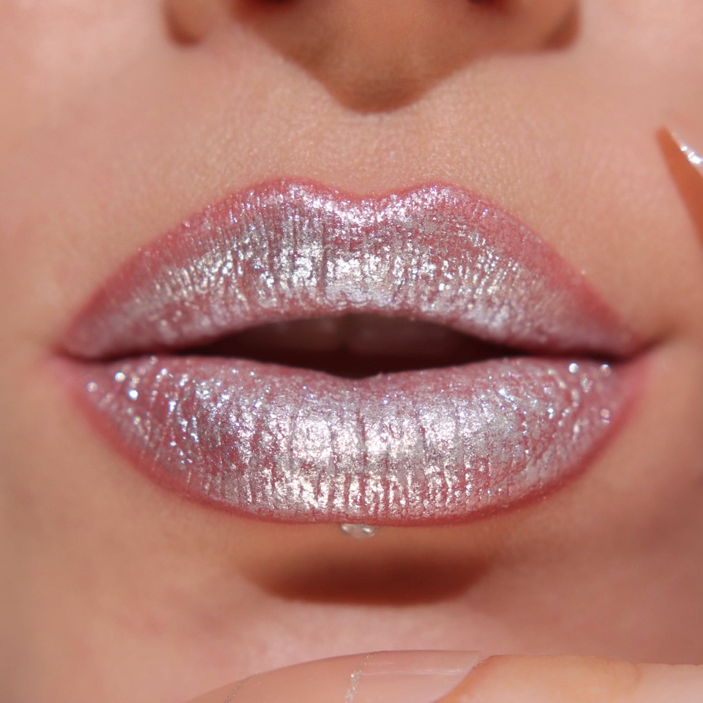 A close up of a models lips wearing the glitter gloss in he shade Silver.